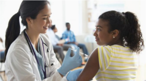 Doctor giving patient injection in volunteer clinic